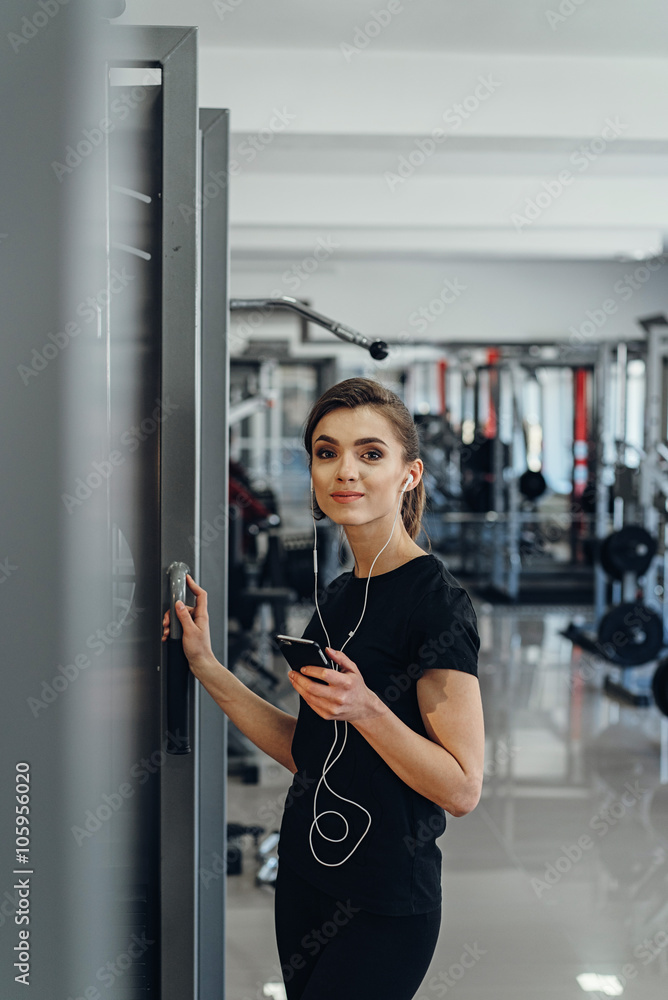 Girl with headphones at the gym Girl with headphones at the gym