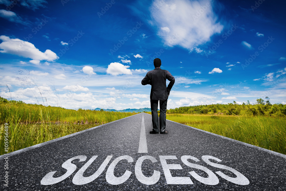 success concept with businessman standing on long road success concept with businessman standing on long road