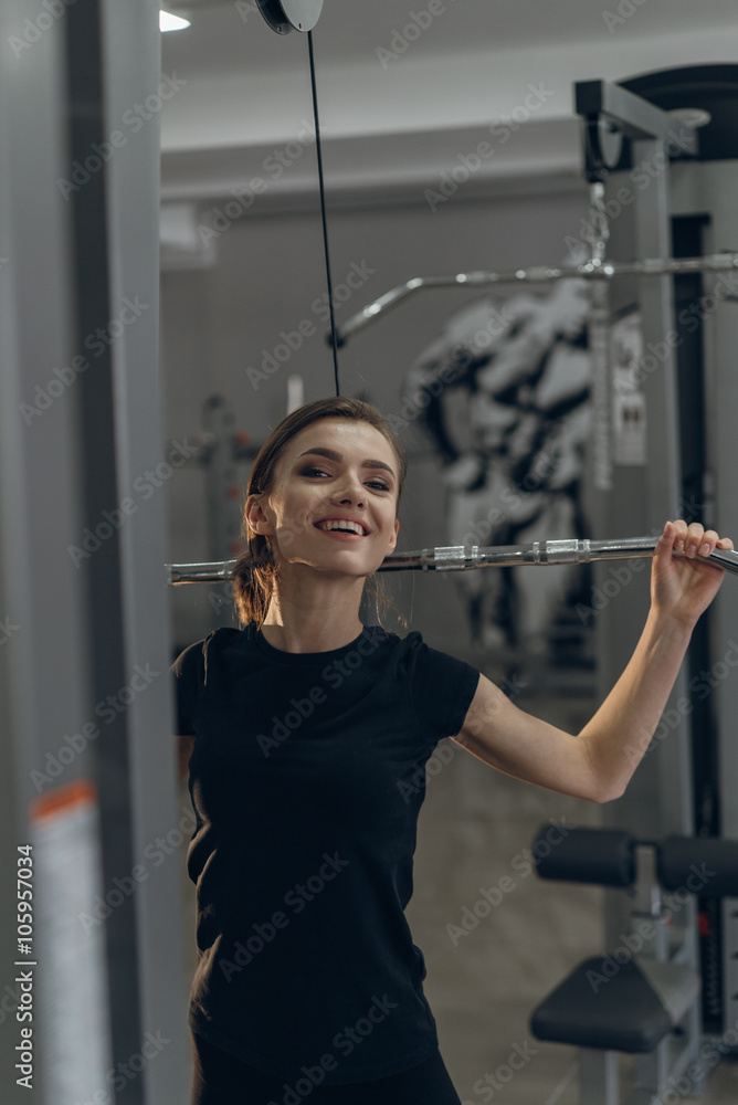 Young girl in the gym performing exercises