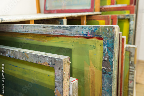Fotografia Silk screen printing screens stored in a wooden rack ready for printing