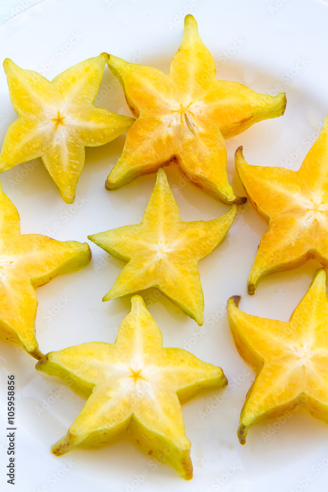 Starfruit slices on a white plate. Starfruit slices on a white plate.
