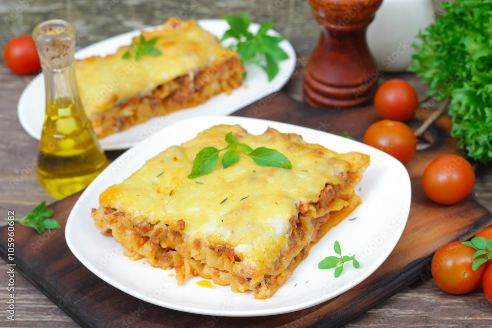 Classic Lasagna with bolognese sauce on a wooden background. Italian food