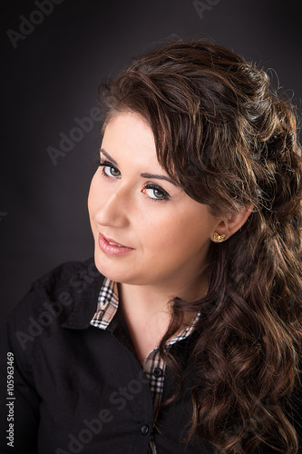 portrait of a young woman on a black background