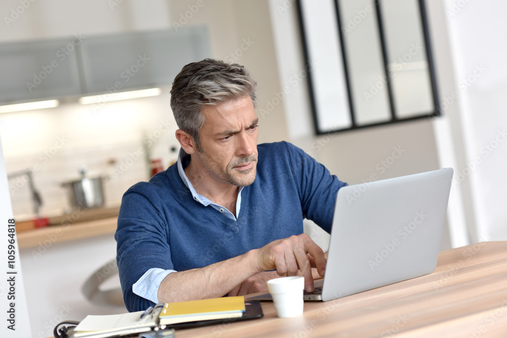 Man working from home-office with laptop computer Man working from home-office with laptop computer