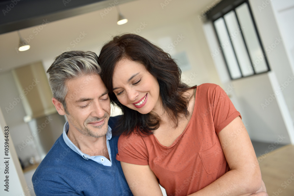Portrait of middle-aged couple enjoying new home Portrait of middle-aged couple enjoying new home