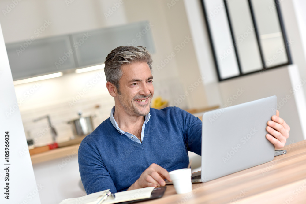 Man working from home-office with laptop computer Man working from home-office with laptop computer