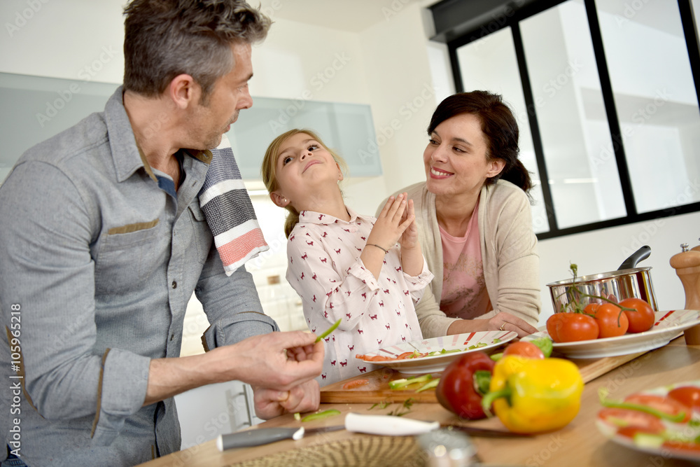 Parents with child cooking together at home Parents with child cooking together at home