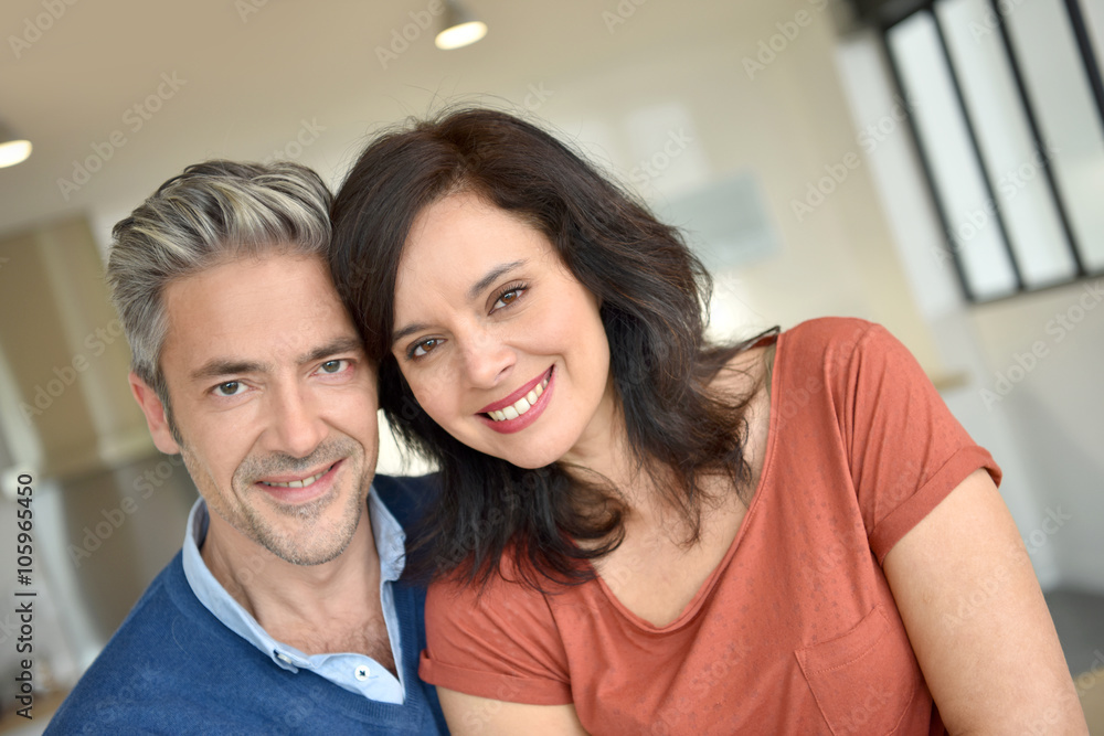 Portrait of middle-aged couple enjoying new home Portrait of middle-aged couple enjoying new home