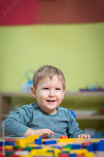 Boy playing with toys in nursery