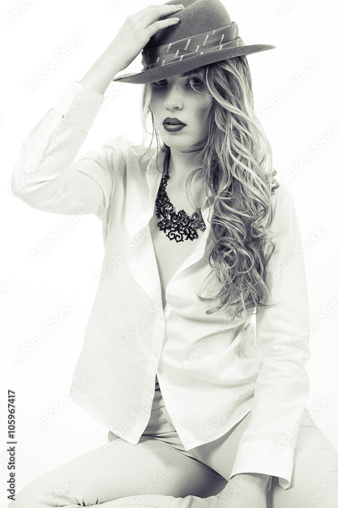 Beautiful girl in a hat portrait. Girl model holding his hat handed. Retro fashion style.