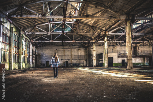 Teen Girl in Empty Factory