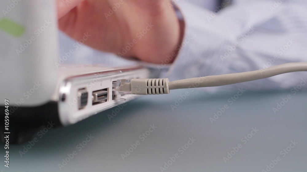 Woman's hand plugging network cable. Woman's hand plugging network cable.