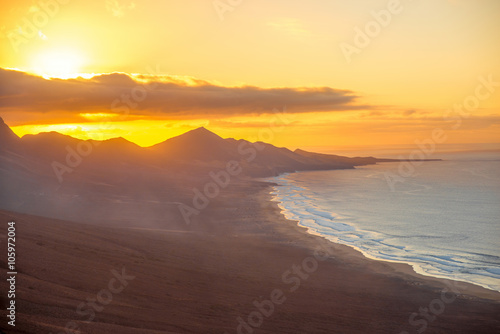 Top view on Cofete beach and mountains on Jandia peninsula on Fuerteventura island on the sunset in Spain