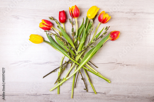 Color tulips on wooden background with copy space for message. Top view. For Mother s Day  Woman s day or Wedding day