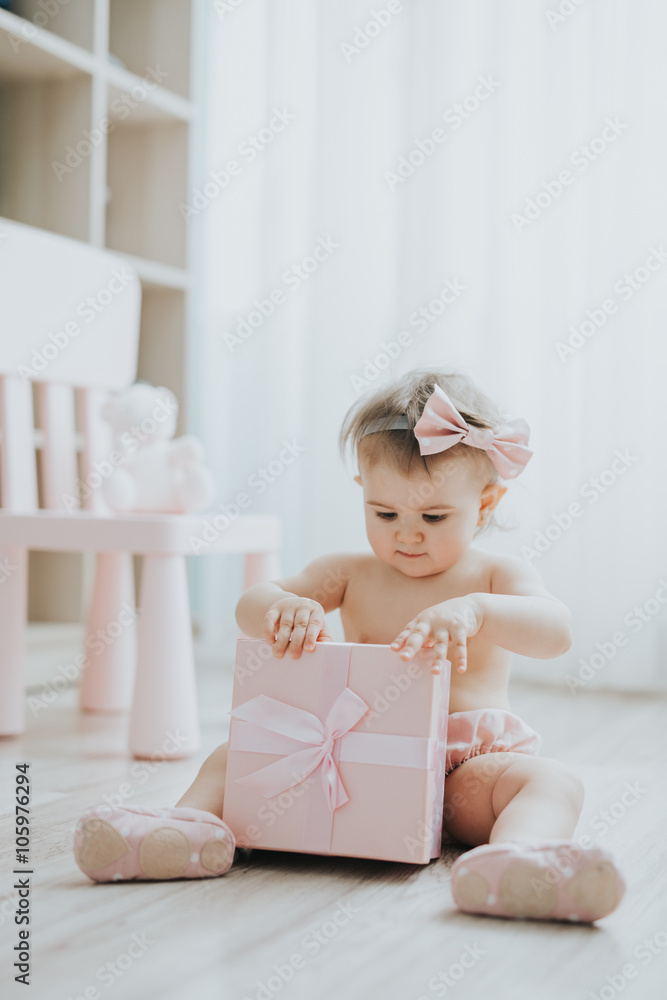 Cute baby girl playing in a white room in the morning with toys Cute baby girl playing in a white room in the morning with toys
