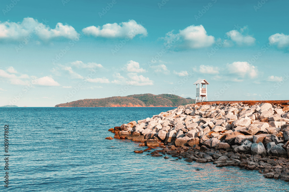 The rock pier in the calmness sea with vintage color tone