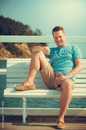 Handsome man tourist on pier. Fashion summer. © Voyagerix