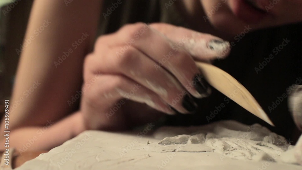 She is engaged in painting on wood She is engaged in painting on wood