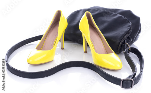Yellow high heels shoes with black handbag