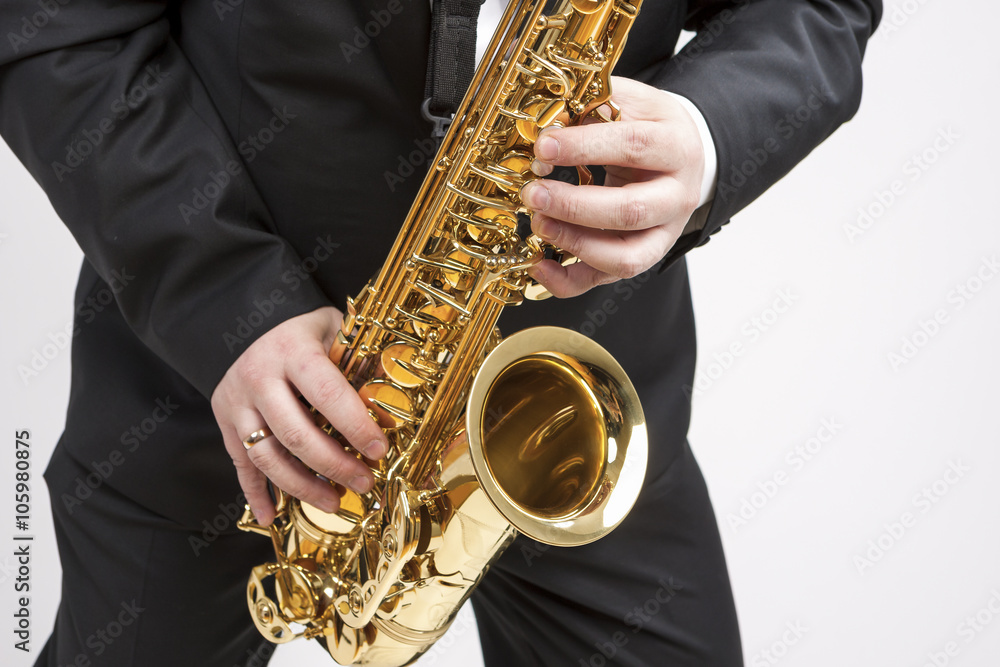 Fototapeta premium Mucs Concept. Closeup of Hands of Saxophone Player Playing on Saxophone