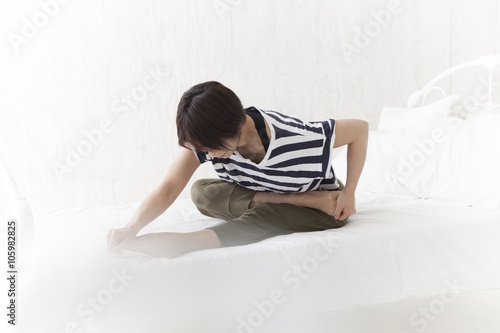 Women have a stretch on the bed before going to sleep