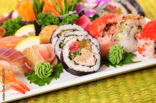 Assorted sushi with ginger and wasabi on bamboo mat