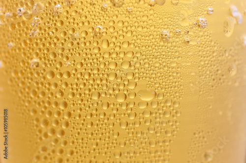 Closeup Orange beer and white froth background.