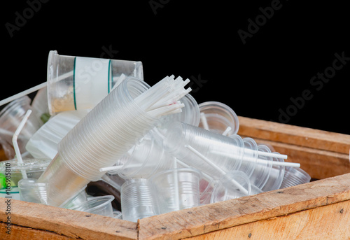 Heap of Plastic cups used in the bin wood, Black background