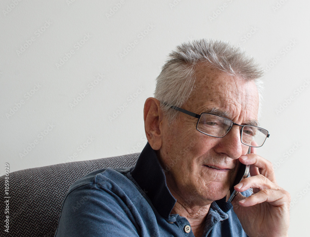 Close up of older man in glasses and blue shirt using smart phone Close up of older man in glasses and blue shirt using smart phone