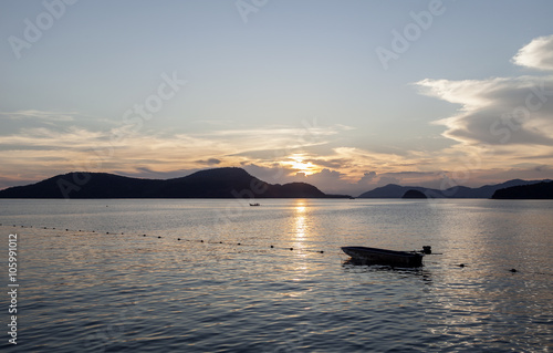 Small boat at sunset ,beautiful scenery background.