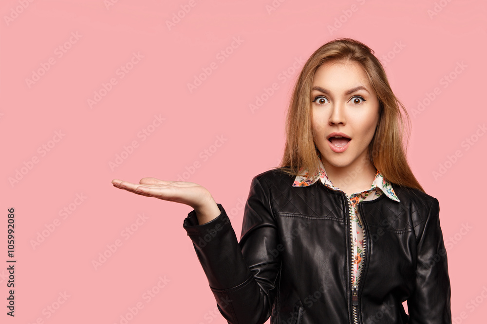 Beautiful young girl shows emotion on a pink background. Beautiful young girl shows emotion on a pink background.