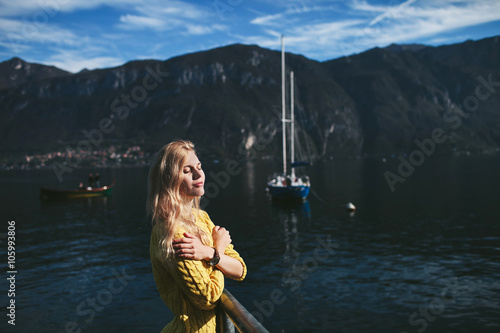 girl standing on a pier of Lake Como © stock.film