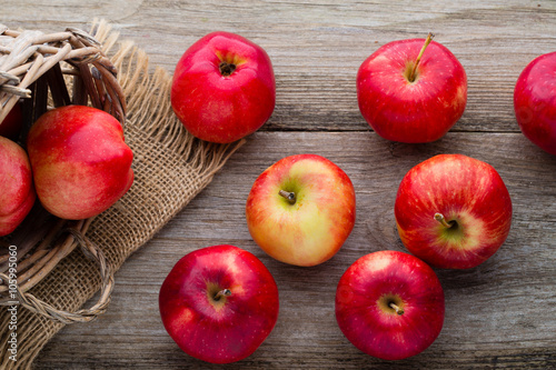 Ripe red apples on wooden background.
