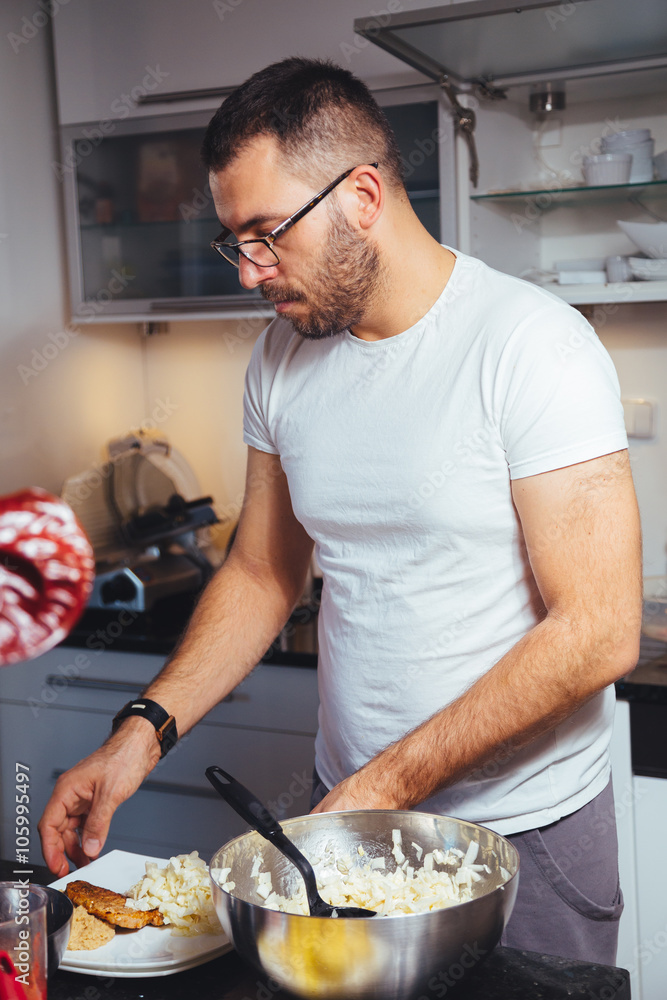 man cooking food in kitchen man cooking food in kitchen