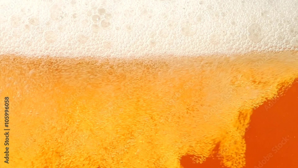 Beer is poured in a glass. Closeup. Slow motion Beer is poured in a glass. Closeup. Slow motion