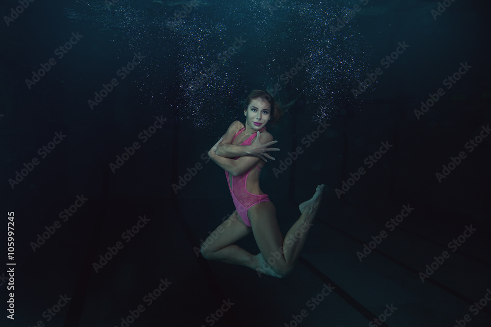 Woman under water shows figures. Woman under water shows figures.