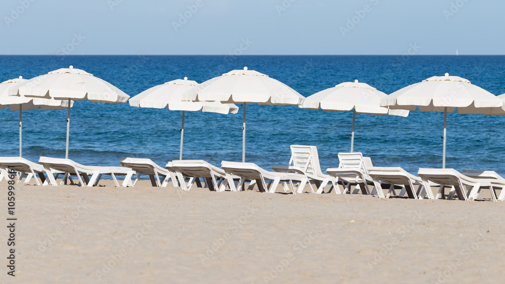 chairs with white umbrellas on the beach