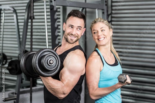 Couple posing with dumbbells