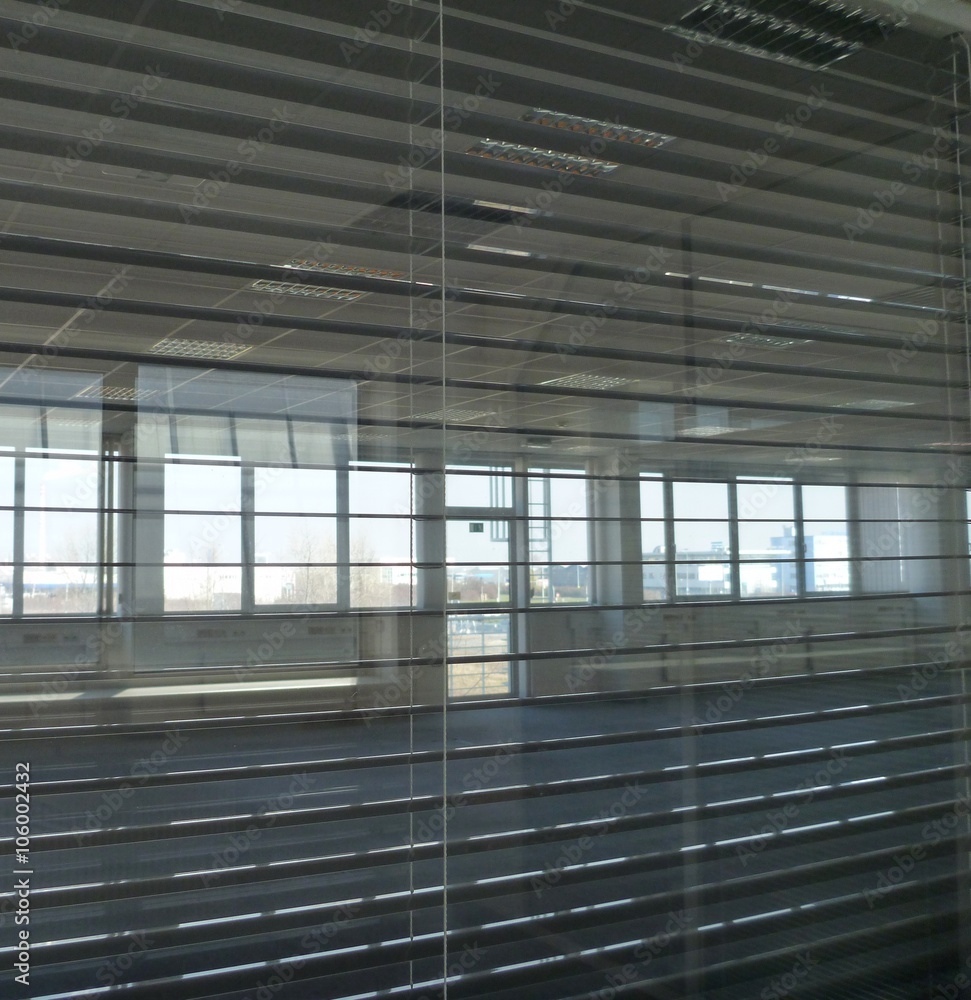 view through office blinders in an empty building view through office blinders in an empty building