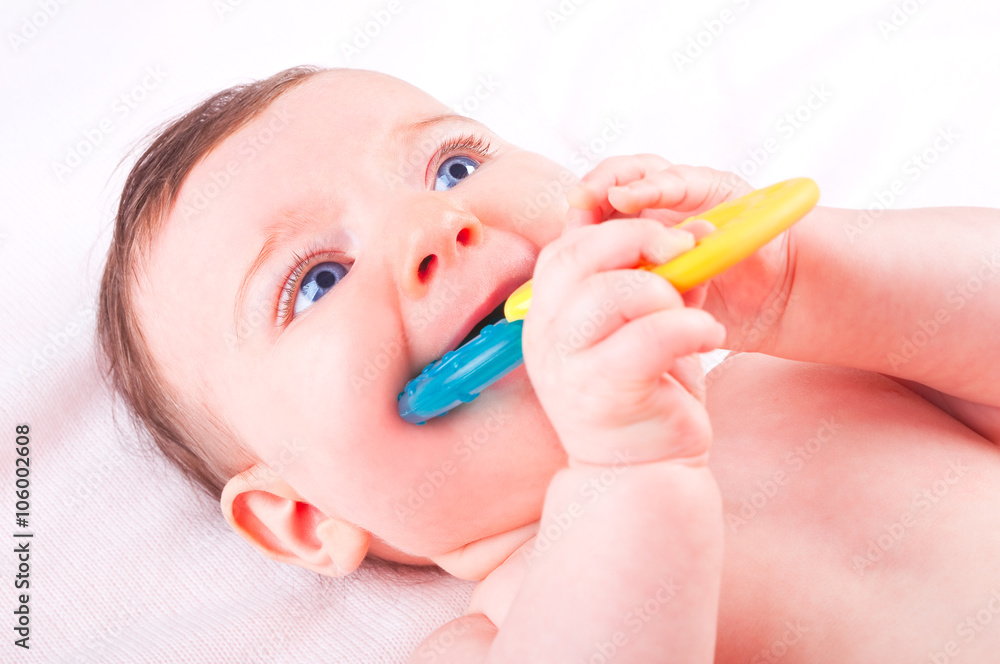 Baby girl with rattle teether toy. Baby girl with rattle teether toy.
