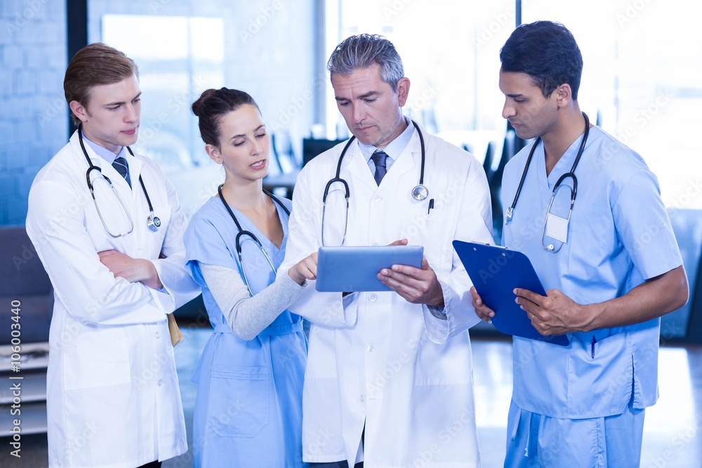 Doctors looking in digital tablet Doctors looking in digital tablet