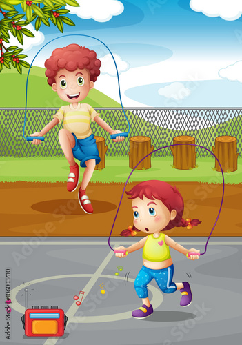 Boy and girl doing jumprope in the park