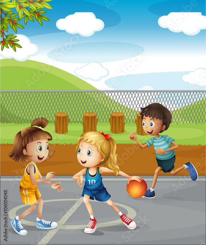 Children playing basketball at the court
