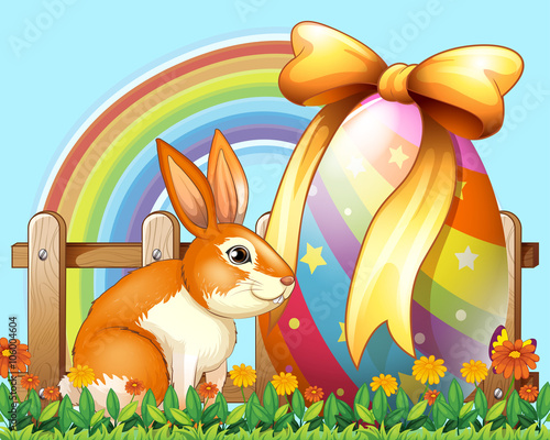 Easter rabbit with egg in the yard