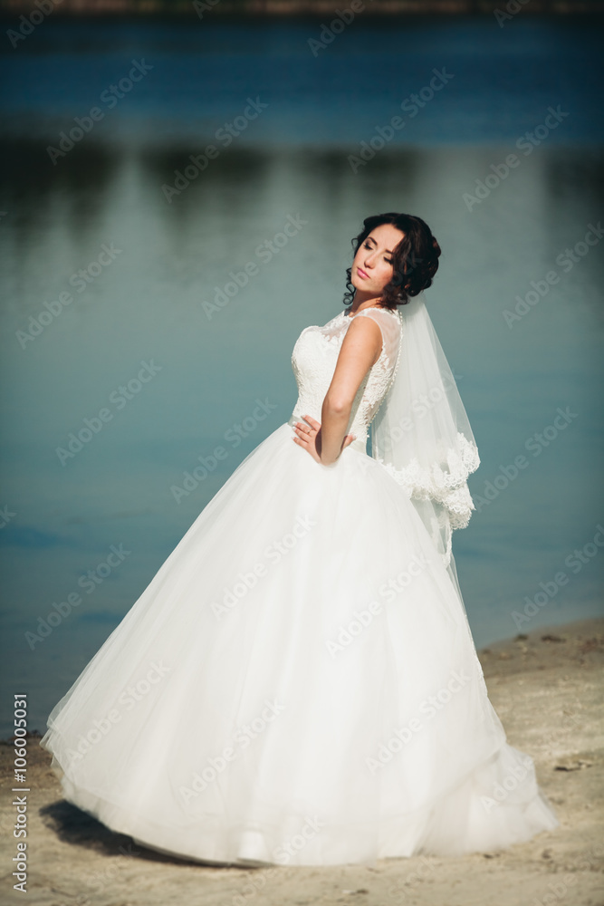 Beautiful luxury bride posing with a bouquet outdoors 