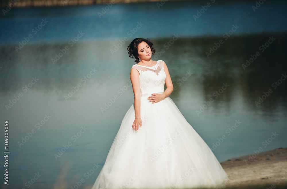 Beautiful luxury bride posing with a bouquet outdoors Beautiful luxury bride posing with a bouquet outdoors
