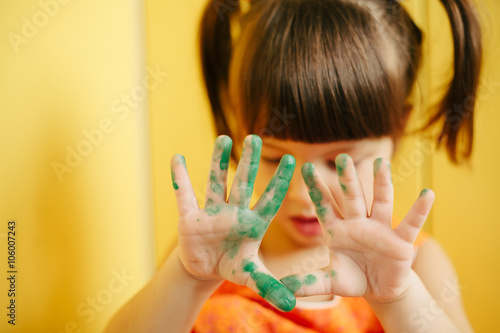 girl showing painted hands