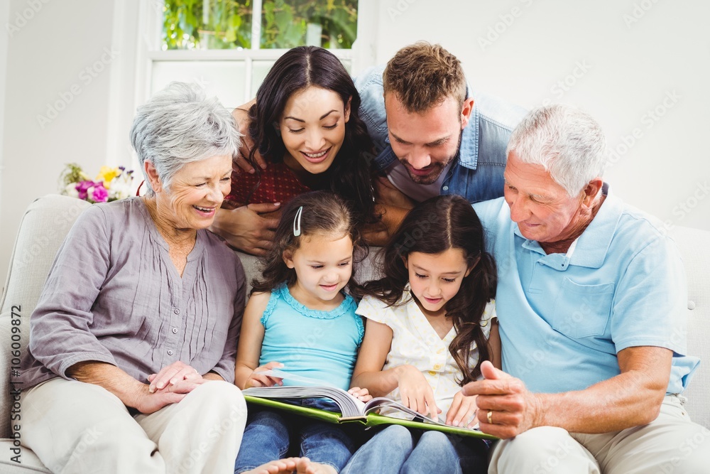 Family assisting girls while reading book Family assisting girls while reading book