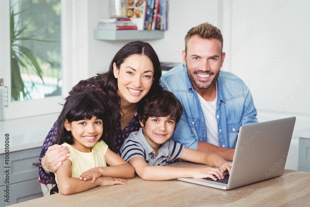 Portrait of smiling family using laptop Portrait of smiling family using laptop