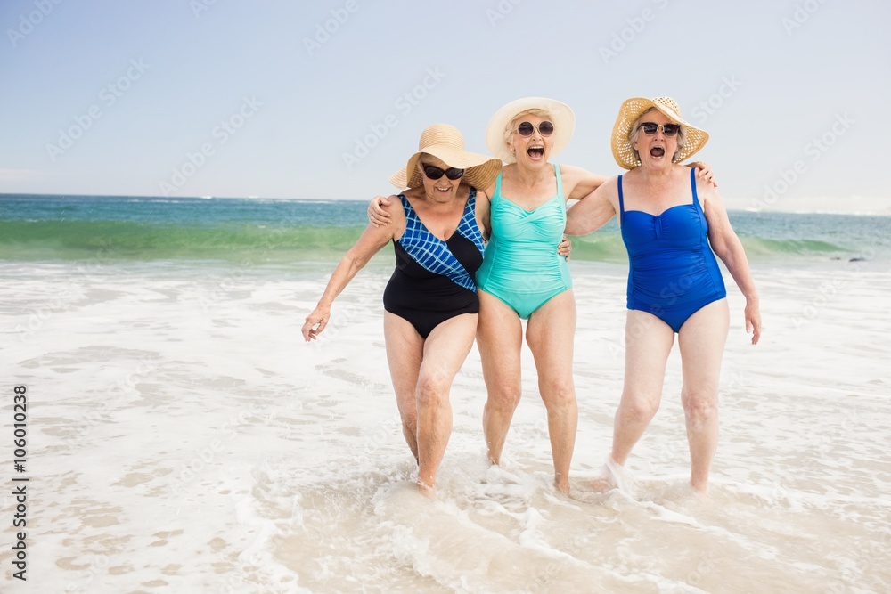 Senior woman friends playing in water Senior woman friends playing in water